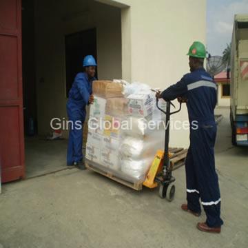 GGSL crew in branded coveralls and hard hats moving a palletised load with a pump truck