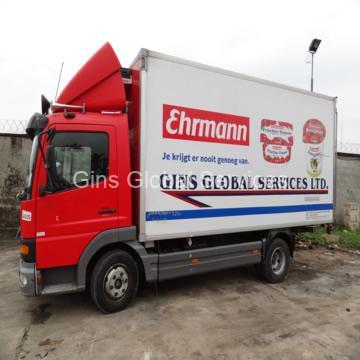 Refrigerated Mercedes-Benz Ehrmann-branded delivery truck at the yard