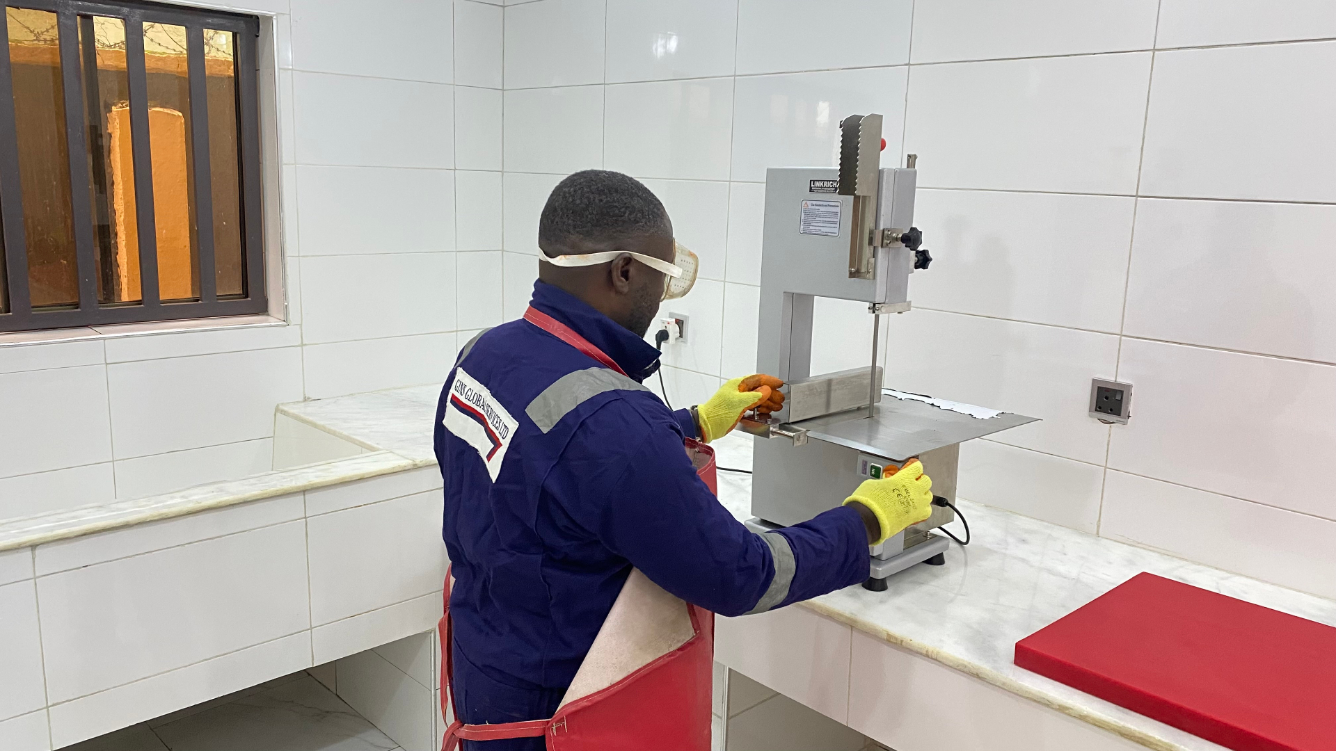 Branded coveralls and cut-resistant gloves at the prep line