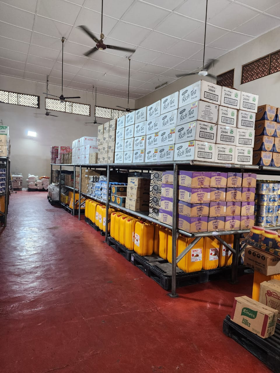 Dry stores racking with cooking oil, biscuits and packaged goods
